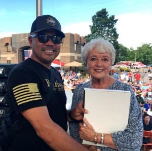 State Senator Janice Bowling presented a flag to Jeremiah Ledda of Los Angeles California, retired from the US Navy at the Fiddlers Jamboree Friday night