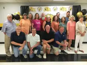 Twelve of the 22 students from the 1974-75 kindergarten class at DeKalb West School attended a reunion at the school Saturday evening along with four former DWS teachers now retired: Pictured left to right front row: Mike McMillen, Steven Brown, Jon Foutch, and Tim Rowland. Middle row left to right: Danny Parkerson (former teacher/principal), Genrose Davis (former teacher), Karen Robinson, Kellie Sandlin Taylor, Stacey Mullinax Martin, Monica Kimbrell Reynolds, Carol Hale (former teacher), and Carolyn Mullinax (former teacher). Back row left to right: Leigh Ann Williams Prince, Tony Vickers, Kerry Davis, and Greg Fish.