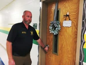 Chief Deputy Brian Williams of the DeKalb County Sheriff’s Department checking doors at Northside Elementary School during a lock-down intruder drill Monday