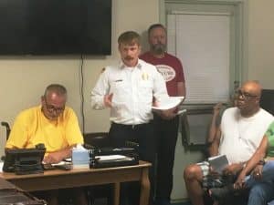 Alexandria City Recorder Jeff McMillen making notes as Fire Chief John Partridge addresses the Mayor and Aldermen Tuesday night