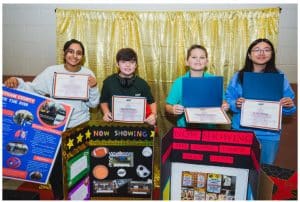 Pictured (L to R): Zoie Chandelkar of Cheatham County, Spencer Burns from Dyer County, Christian Cripps of DeKalb County, and Chloe Zheng of Putnam County showcase their awards and creations which placed 1st, 2nd, 3rd, and Fan Favorite, respectively, in the 2024 TNSTRONG Youth Summit poster contest, July 21 to July 23, 2024, in Chattanooga, Tenn.