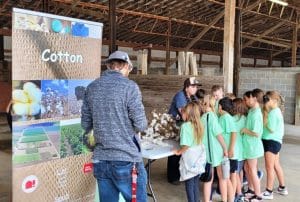 Madison Judkins, Young Farmers and Ranchers Member, explains how cotton plants are used to make clothing and other products.