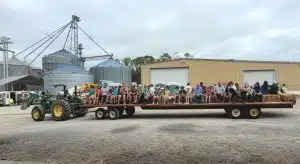 Third grade students and guests take a hay ride tour of Herndon Farms