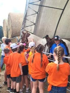 4-H/FFA Member Gauge Pack teaches students about his horse at Farm Day.