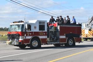 Smithville fire truck bearing the flag draped coffin of DeKalb EMS Director and Deputy Smithville Fire Chief Hoyte Hale and his fellow firefighter and EMS pallbearers approach gravesite at DeKalb Memorial Gardens