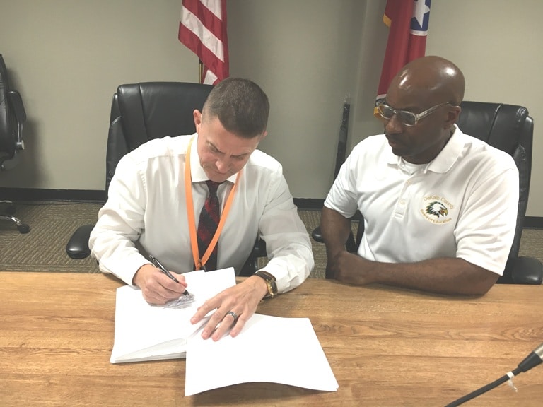 Director of Schools Patrick Cripps Signs Three Year Contract Extension with School Board Chairman Shaun Tubbs looking on.