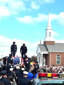 Following the funeral service Wednesday afternoon at the First Baptist Church Life Enrichment Center, DeKalb EMS Director and Deputy Smithville Fire Chief Hoyte Hale’s flag draped coffin was carried by fellow Smithville firefighters and EMS co-workers and then placed aboard a fire truck before being taken along the route to the cemetery with full firefighter honors.