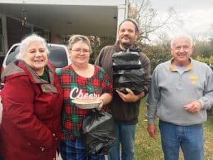 The reward: Larry and Natalie Green deliver Thanksgiving Day meals to Jonathan and Angela Ferrell on behalf of the DeKalb Emergency Services Association: Pictured left to right: Natalie Green, Angela Ferrell, Jonathan Ferrell, and Larry Green.