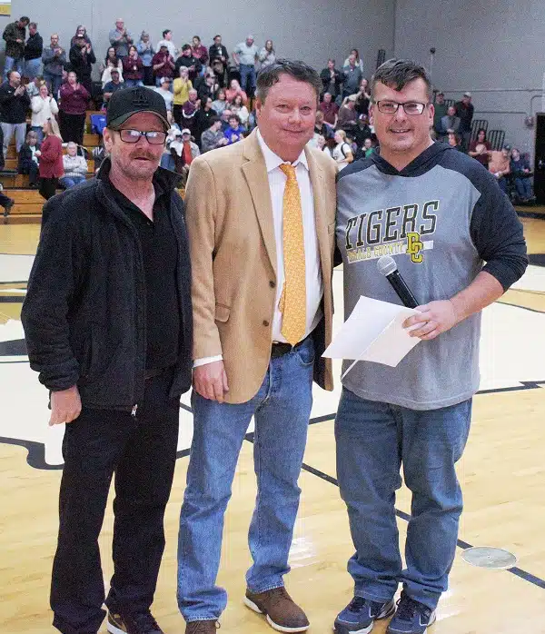 More than 40 years after he coached his last DeKalb County High School basketball game, the late legendary coach Harold Luna was recognized during Monday night’s DCHS basketball games as they played host to Cannon County. Last year, the Board of Education voted to name the DCHS gym floor in honor of Coach Luna, who passed away in December, 2022 at the age of 85. A brief ceremony was held Monday night between the boys and girls games to dedicate the naming of the gym floor in honor of Coach Luna. Pictured left to right: Coach Luna’s sons Buck and Rocky Luna and Emcee Tom Duggin