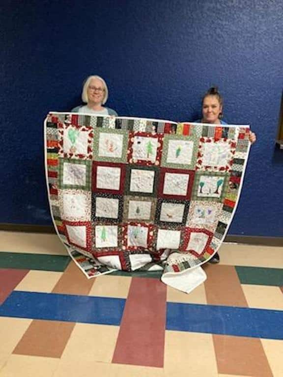 PatchWork UC blessed 4 DeKalb County residents with quilts this year. 3 were made from blocks that children created at the 2024 Regifting Event. The 4th was a handmade donated lap quilt. Patty Warner on the right nominated her friend Curtis. Kim Walker, Regifting Event Coordinator