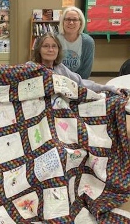 PatchWork UC blessed 4 DeKalb County residents with quilts this year. 3 were made from blocks that children created at the 2024 Regifting Event. The 4th was a handmade donated lap quilt. Patricia Bryant,  left Kim Walker, right