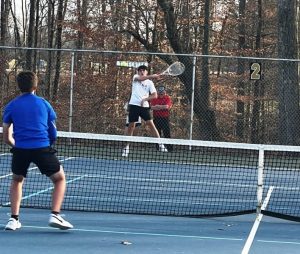 Ian Barnes in doubles action against Macon County.