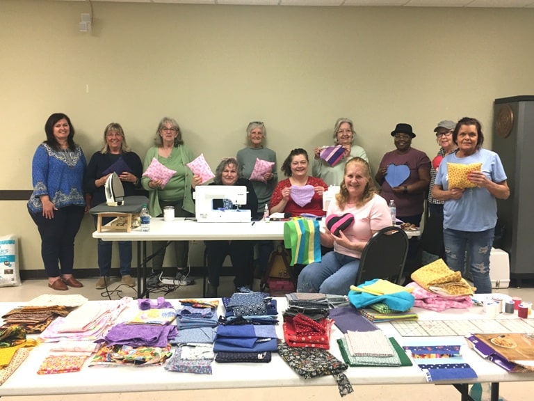 Members of the local FCE Club met Wednesday to put their sewing skills to good use by assembling a variety of comfort cushions, primarily for breast cancer survivors who have undergone treatment and surgery. The comfort cushions will be donated to an area breast cancer clinic and dispersed to future patients. Pictured left to right: April Martin, Debbie Geier, Pat Wilt, Bea Garrison (seated), Gail Taylor, Jaime Cantrell (seated), Carolyn Cantrell, Jenny  R. Reichenbach (seated), Mary Sanders, Joan Hamilton, and Pat Milam. Not pictured: Natalie Green